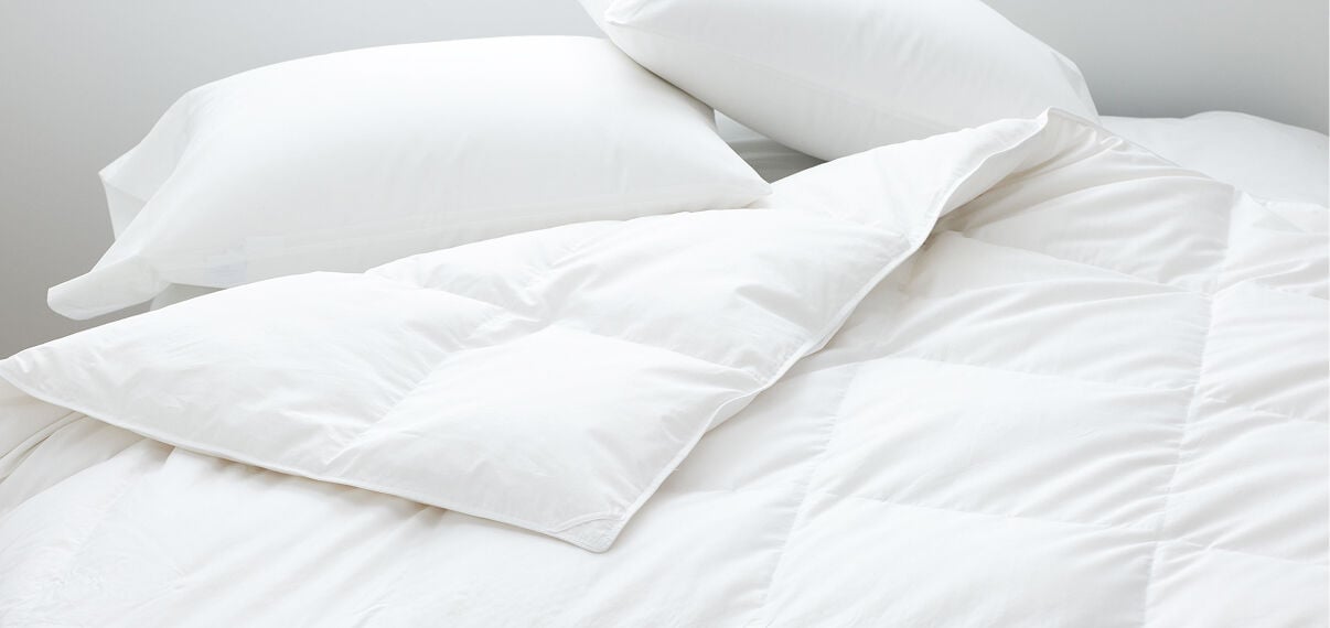 Image of a white duvet insert and pillows